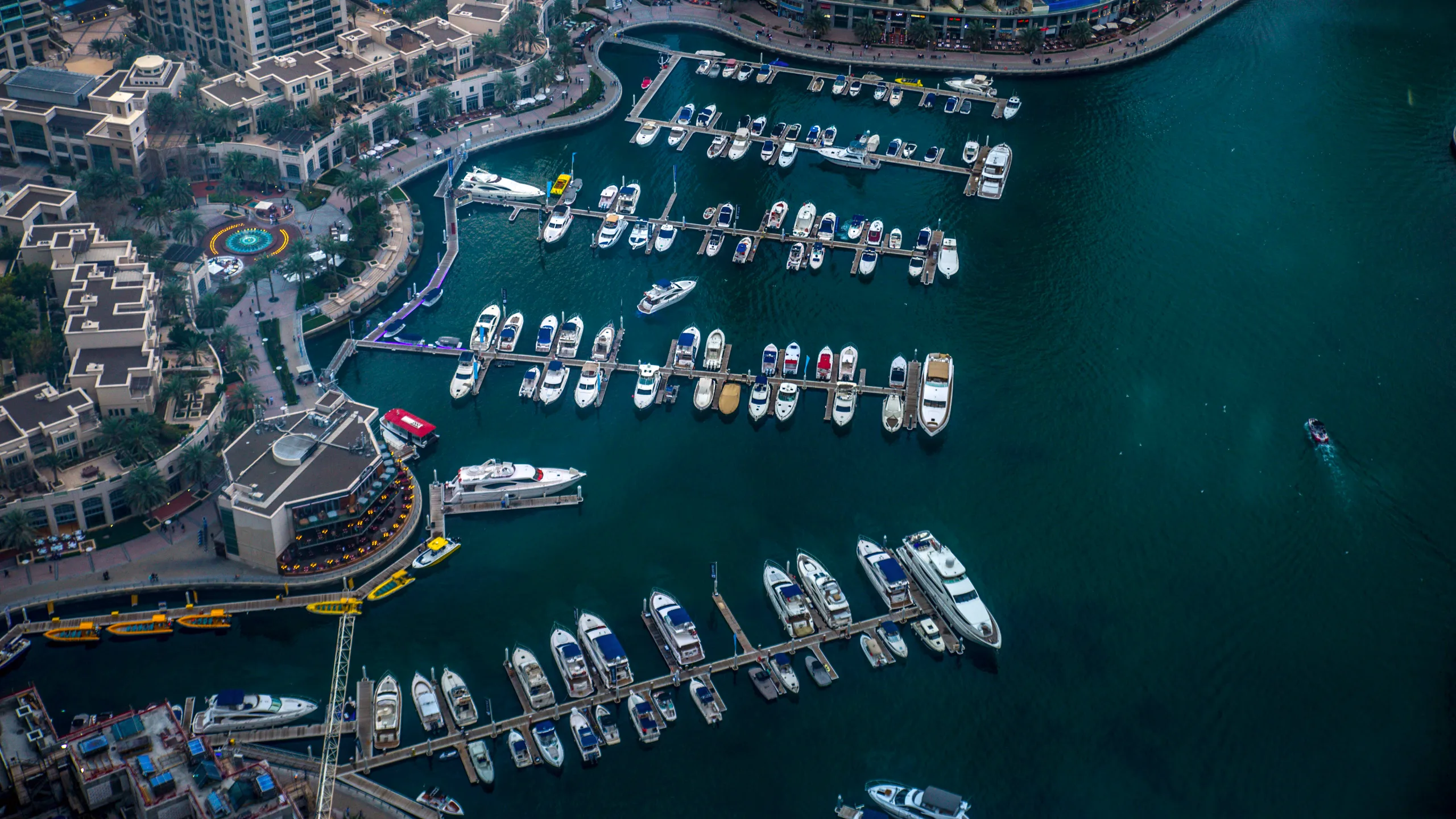 Aerial Shot of Dubai Marina Walk showing the moored boats and modern architecture of Dubai