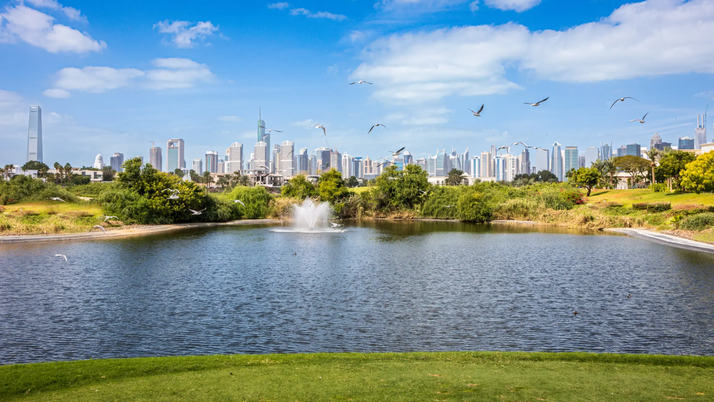 View over the Emirates Hills lake towards the Dubai skyline