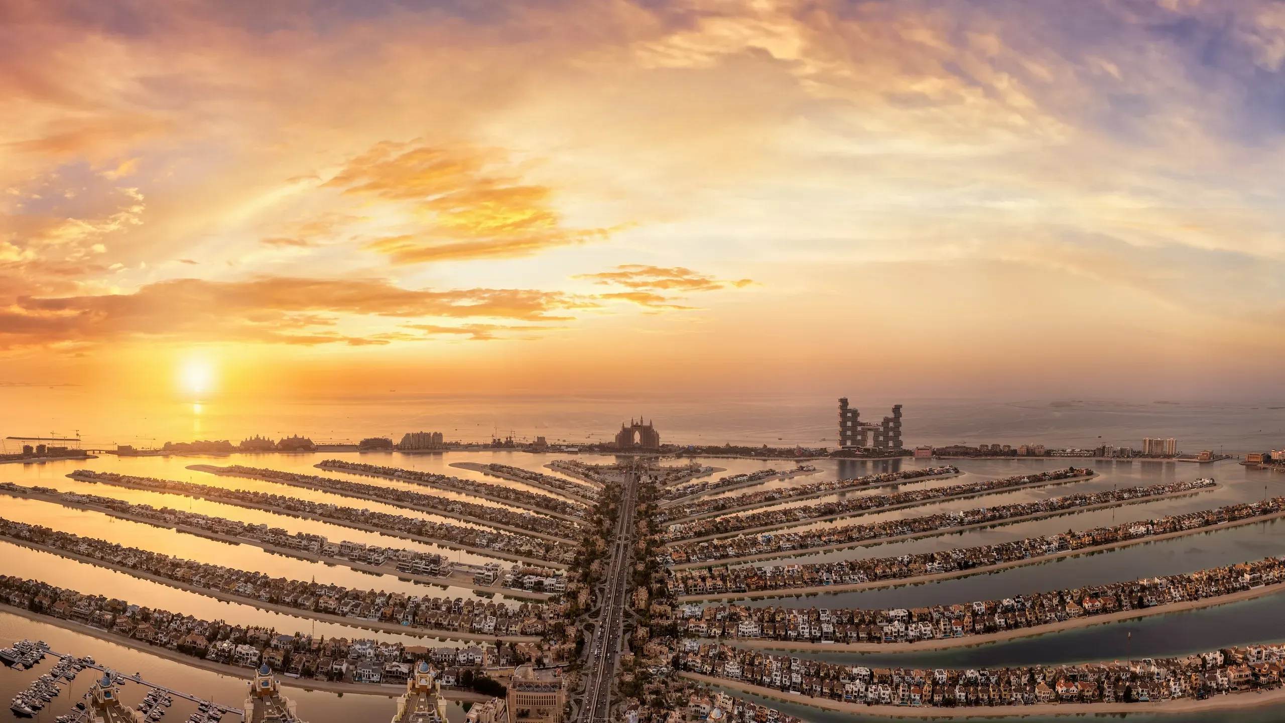 Aerial view as the sun sets over the spectacular Palm Jumeirah island in Dubai