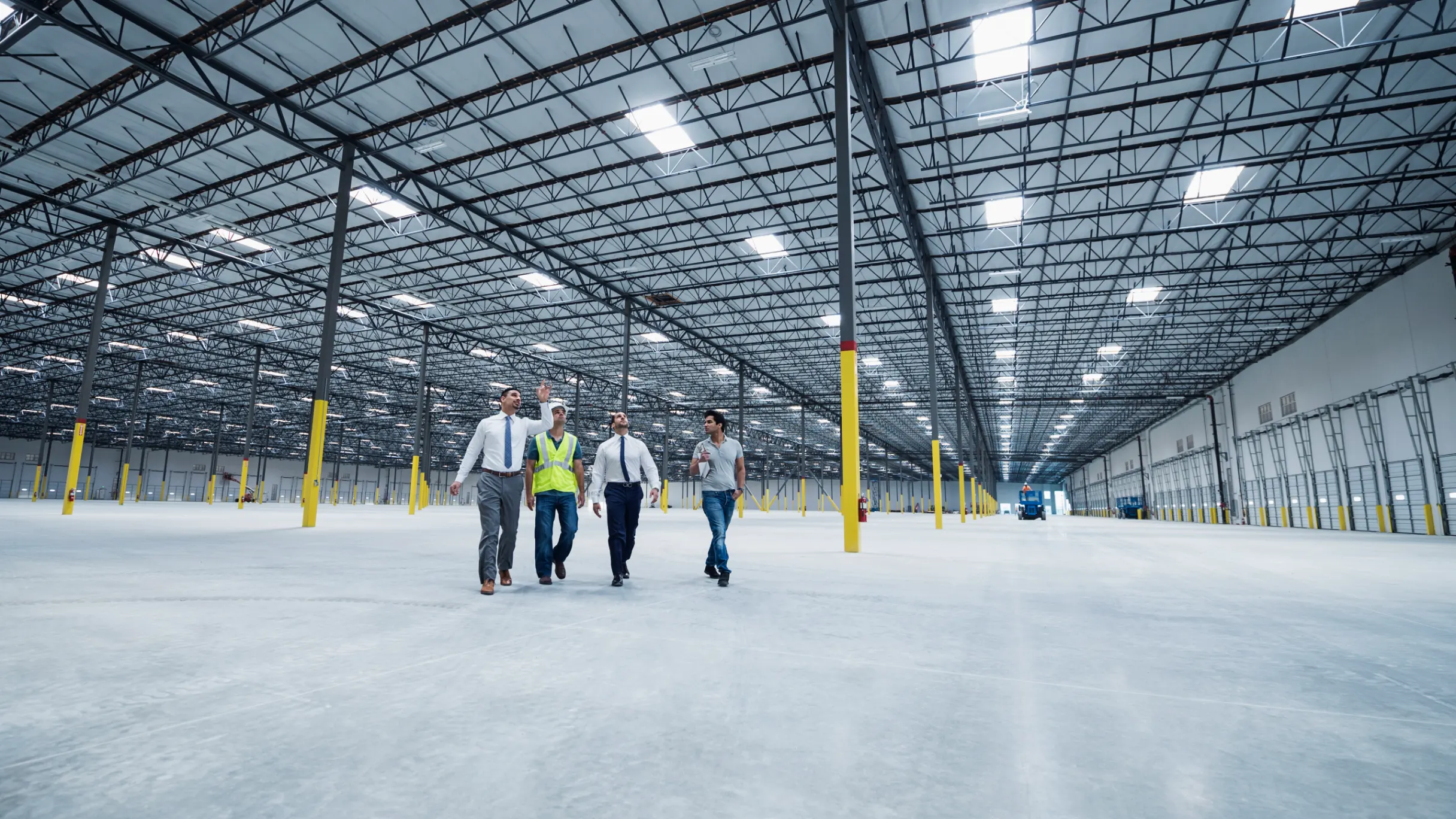 Businessmen walking and talking in an empty warehouse