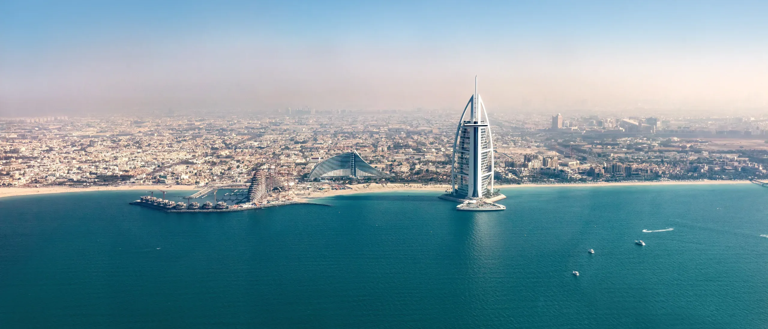 Aerial view over the busy sunny shoreline of Dubai